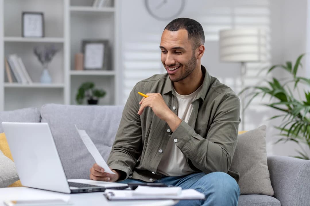 young-man-working-on-laptop-examining-credit-report-and-credit-score