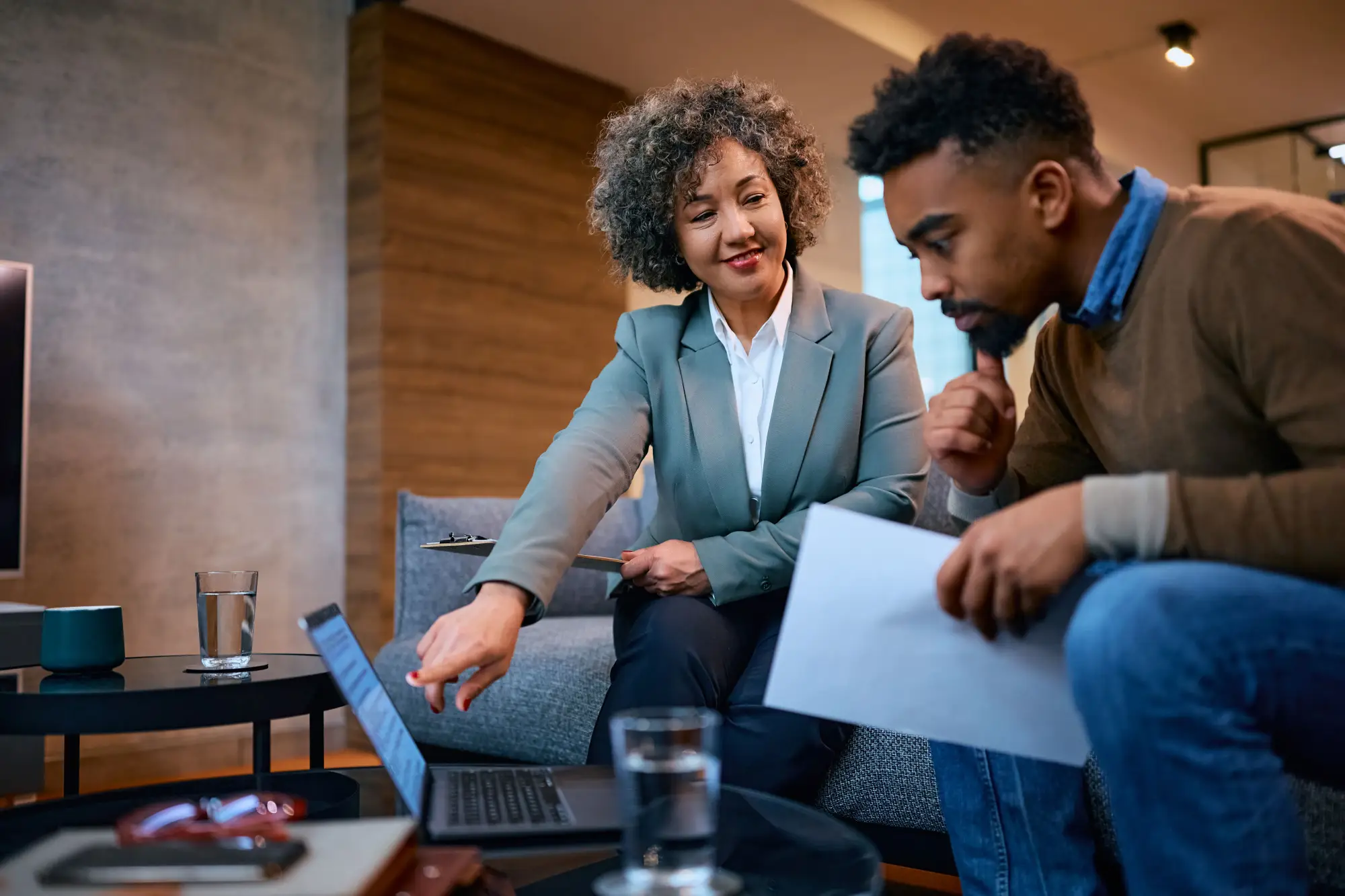 a person at bank meeting with a financial advisor to discuss loan options