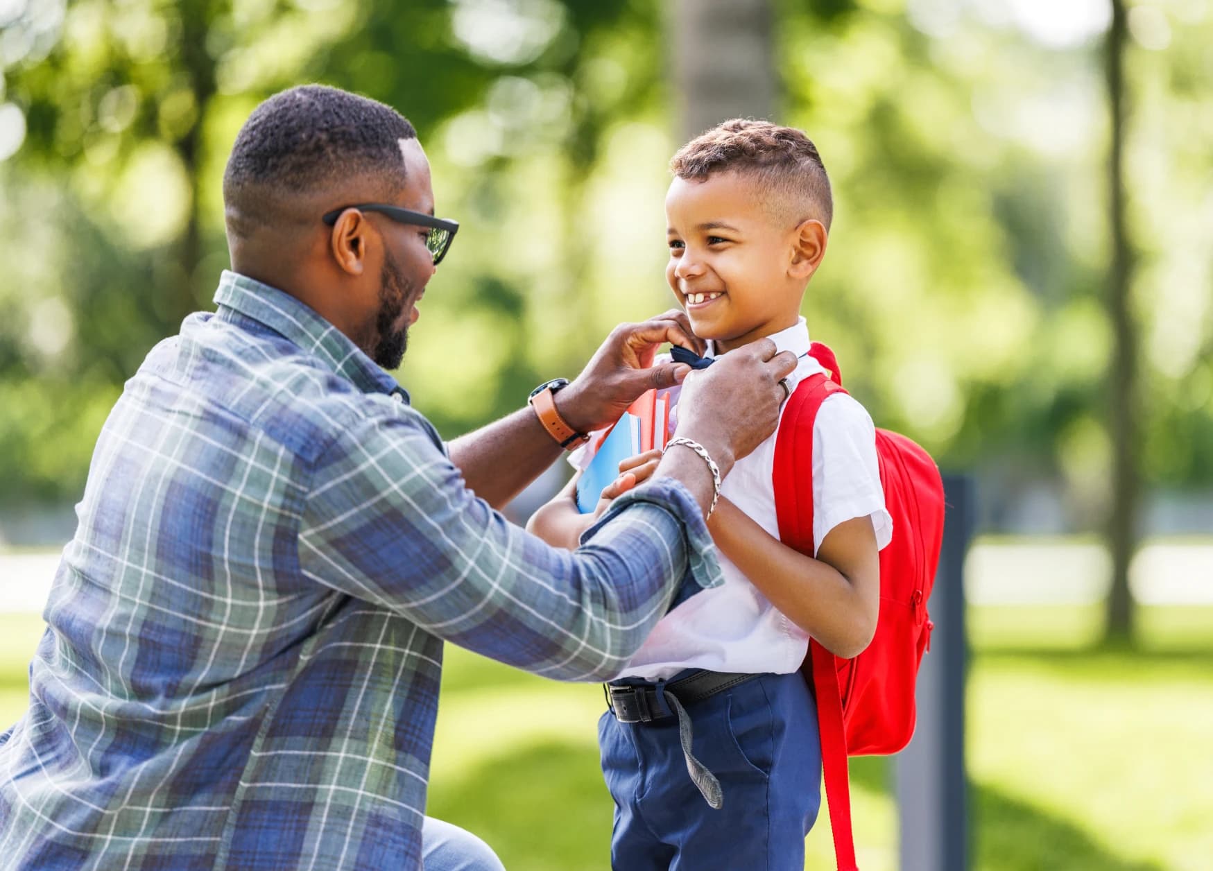 father-helping-young-boy-prepare-for-back-to-school-day-adjusting-bow-tie-before-first-day-of-classes